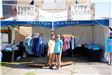 two women smiling in front of retail booth
