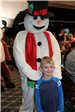 kid posing with frosty the snowman