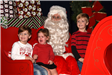 three kids sitting with Santa