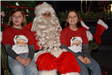two girls sitting with Santa
